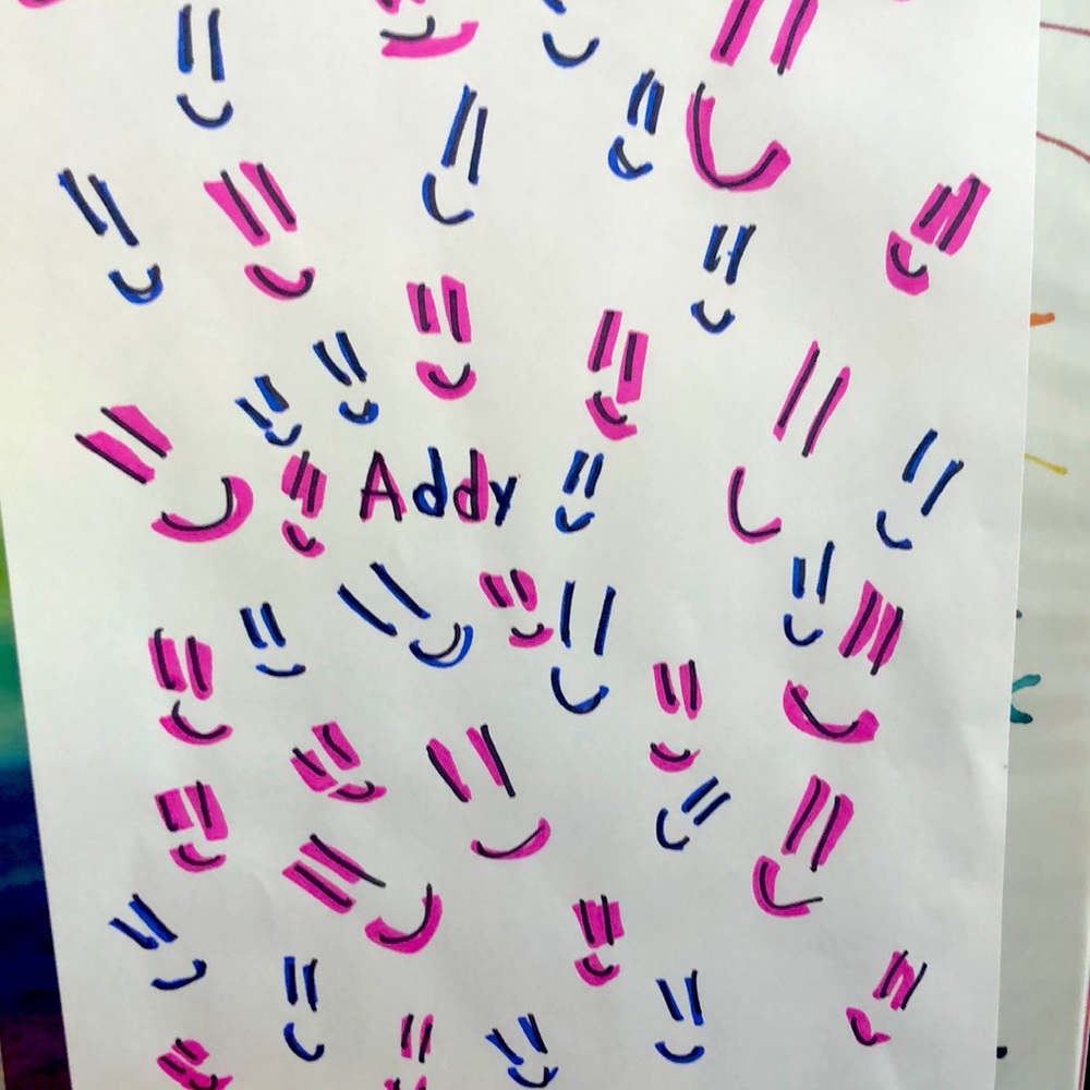 Piece of paper and made by hand smiley face name is addy.